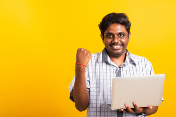 Closeup Asian happy portrait young black man excited holding laptop computer clenching fists and...