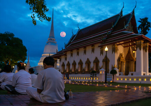 Meditation group with buddha image at Makha Bucha Day in Thailand.