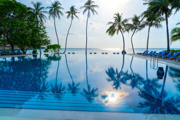Fototapeta na wymiar Private oceanfront pool with submerged loungers in a luxury resort in Maldives, Indian Ocean