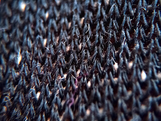 Extreme macro view of a black color cloth texture or pattern.
