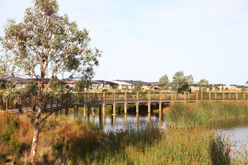 Housing estate located in Clyde North, near Berwick, Victoria featuring lake surrounded by plants and walking tracks.  The future of urban housing and green space