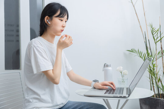 In the study, a pure girl is using a computer