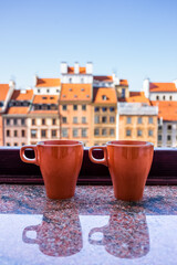 Window sill of apartment tenement with view of old market square in town of Warsaw, Poland and two...