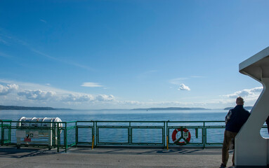 man on ferry looking at horizon