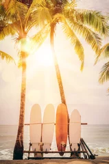 Surfboard and palm tree on beach background. © tonktiti