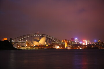 Naklejka premium View of the iconic Sydney Opera House and Harbor Bridge at Night, Sydney, Australia.