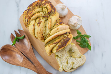 home made braided basil pesto bread on a table