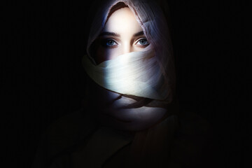 beautiful girl in hijab, looking from the dark. beauty girl in hood
