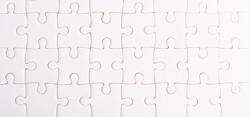 Top view flat lay of paper plain full white jigsaw puzzle game texture background, quiz calculation concept