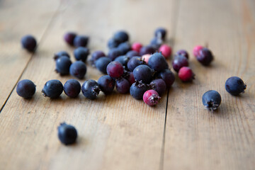honeysuckle berries on a natural wooden background