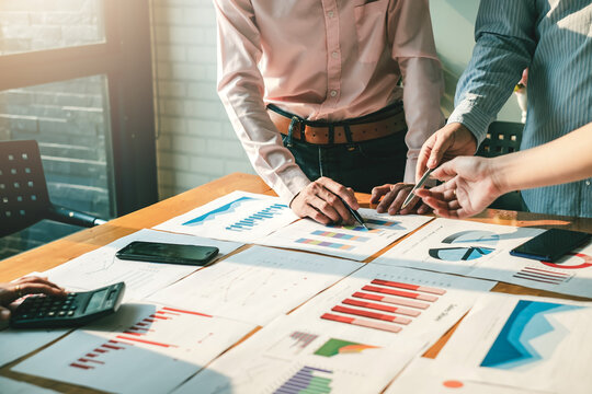 Business people meeting to discuss the market situation and analyze financial concept statistics.