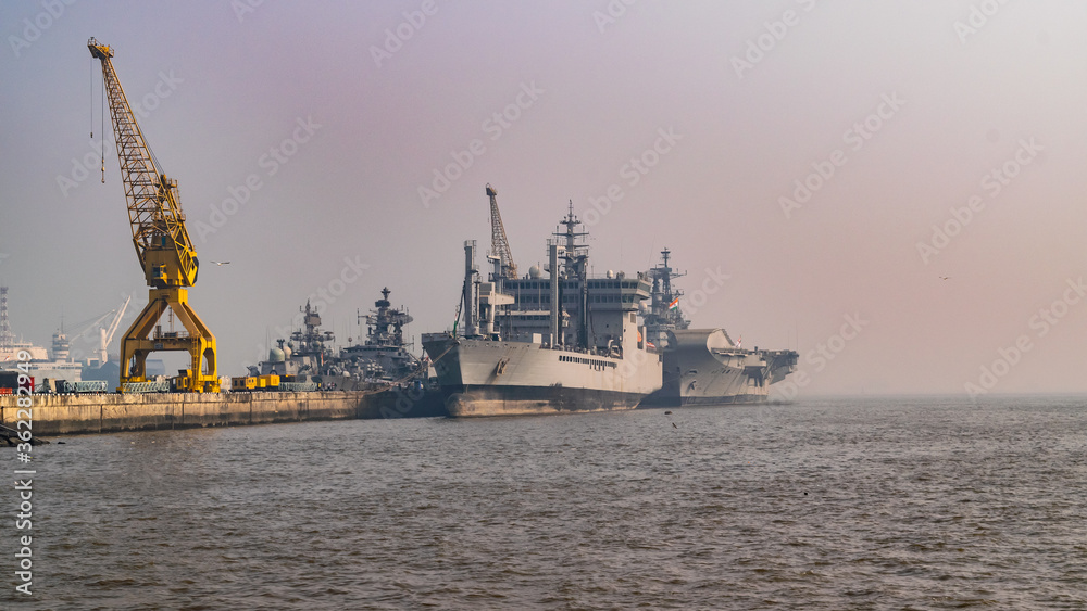 Wall mural dockyard of cargo ships of commercial shipping at anchor in the arabian sea outside mumbai, india's 