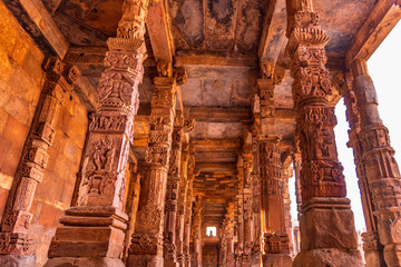 Columns with stone carving in courtyard of Quwwat-Ul-Islam mosque, Qutub Minar complex. It is UNESCO world heritage site at  New Delhi,India