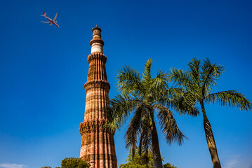 Fototapeta na wymiar Qutub Minar is a highest minaret in India standing 73 m tall tapering tower of five storeys made of red sandstone and marble established in 1192. It is UNESCO world heritage site at New Delhi,India