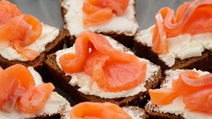 Appetizing Salmon and soft Cheese on Fresh Bread, top view. toast with salmon