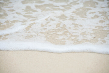 Fototapeta na wymiar Sea wave bubble On the white sand beach
