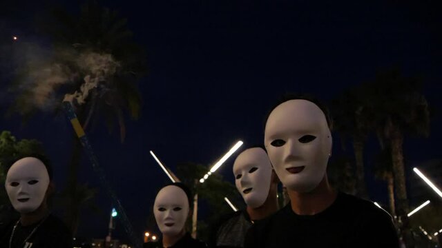 Group with mysterious white masks for non-idenfication using fireworks
