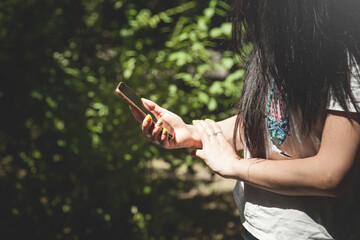 Woman using smartphone in outdoor.