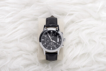 men wristwatch over white