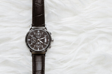 men wristwatch over white