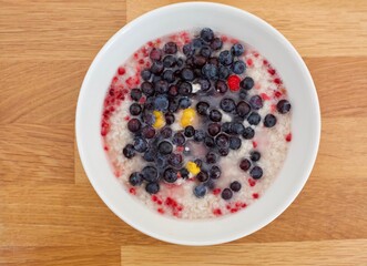 Oatmeal bowl with bilberries, raspberries and a few cloudberries.