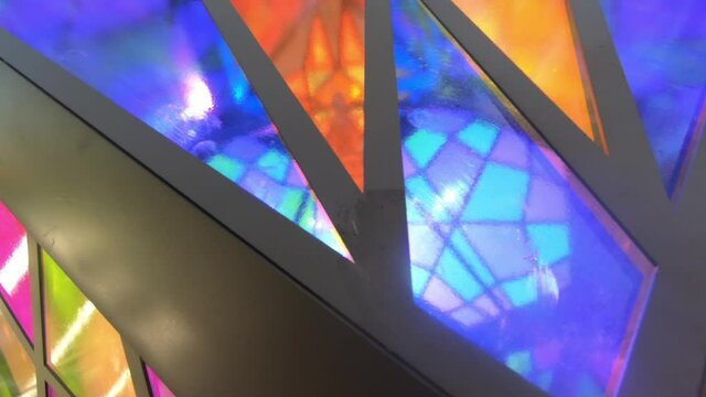 Close up shot, The colorful stained glass art, handcrafted glass into small color pieces of giant rotating art