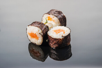 Three rolls of fresh fish, oriental cuisine with a unique taste and spices