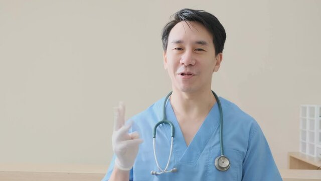 portrait of smart asian doctor explain and suggesting a way to takecare yourself with happiness smiling cheerful Caring for patients at the hospital
