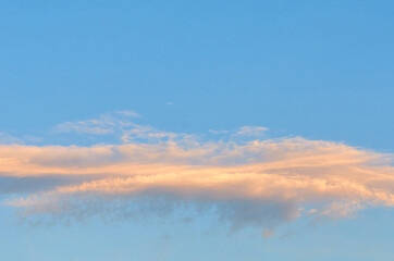 pink clouds on a blue sky at sunset in summer