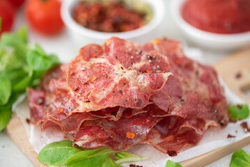 fried crispy bacon with vegetables on parchment