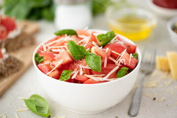 fresh salad of pink tomatoes, parmesan, basil and seasoning