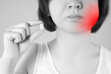 Wisdom tooth extraction, woman suffering from a toothache on gray background