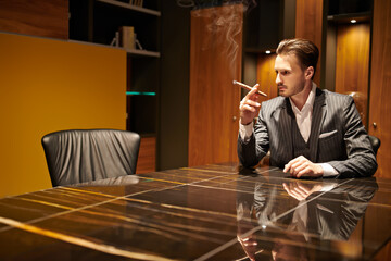 man smokes a cigar