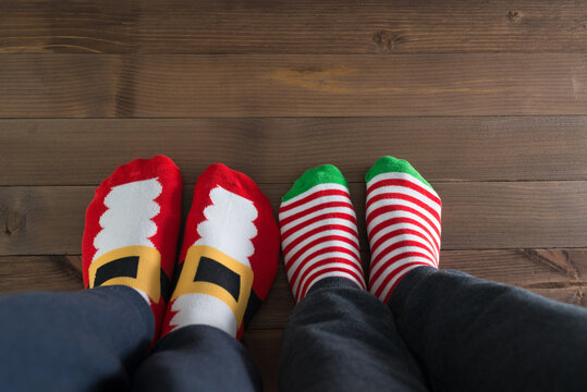 couple withchristmas socks sitting on wooden floor, winter cosy scene
