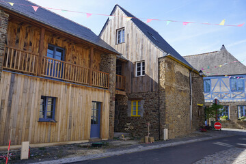 narrow street in an old town with typical stone buildings in Brittany, France