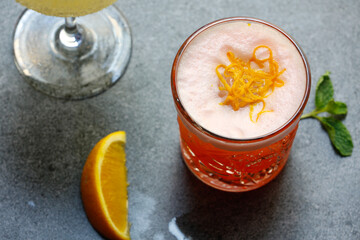 Alcoholic cocktails on a gray background