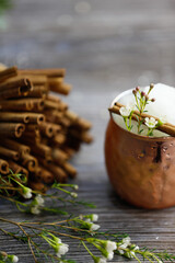 Christmas cocktail with crushed ice in a copper mug on a gray background