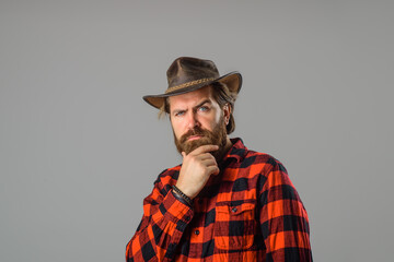 Cowboy couture. Portrait of bearded man wearing cowboy hat. Western style men fashion. Handsome cowboy in plaid shirt.