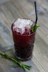 Cherry rum with ice and rosemary 