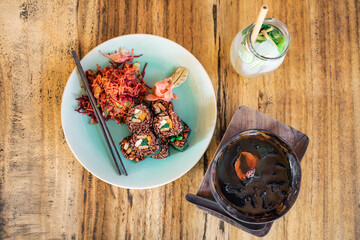 Vegetarian red rice sushi set with vegetable salad, tofu, tempeh, seaweed soup and lemonade. Vegan lifestyle and healthy food. Raw meal.