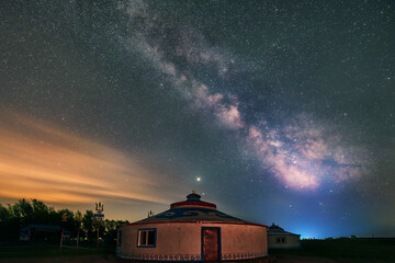 Naklejka na ściany i meble Under the bright Milky Way, Mongolia yurts on the grassland are scattered.