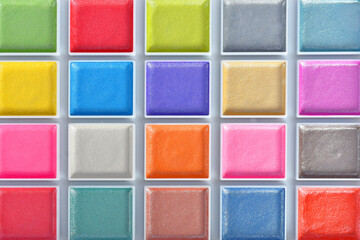 A close up image of a brand new water color paint set in a white plastic case. 