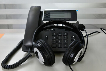 Black headset on table of technical support agent in office