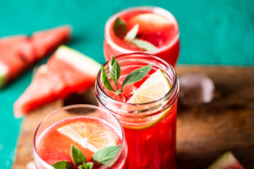 Non-alcoholic watermelon mojito drink. Served on wooden chopping board.