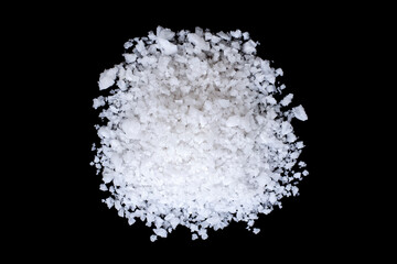 Closeup pile coarse or rock natural sea salt isolated on dark background. Top view. Flat lay.