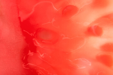 Background with sliced tomato under strong magnification in soft focus. A detailed image of the pulp of a ripe tomato.