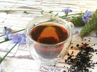 black tea with lemon in a transparent cup