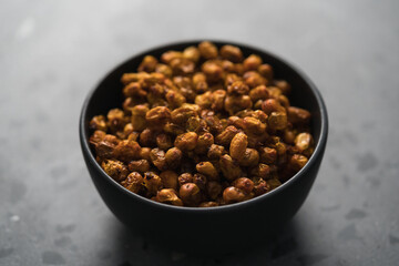 dried seaberry buckthorn in black bowl on terrazzo countertop