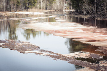 Obraz premium Early spring drift on beautiful river with broken off pieces of ice float down the stream.