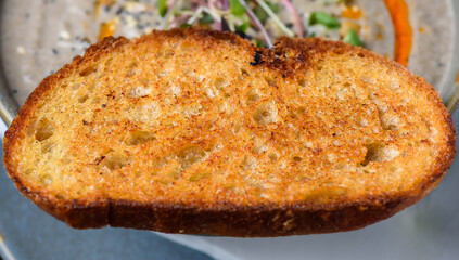 A close view of a slice of toasted bread as know as 'Toast'
